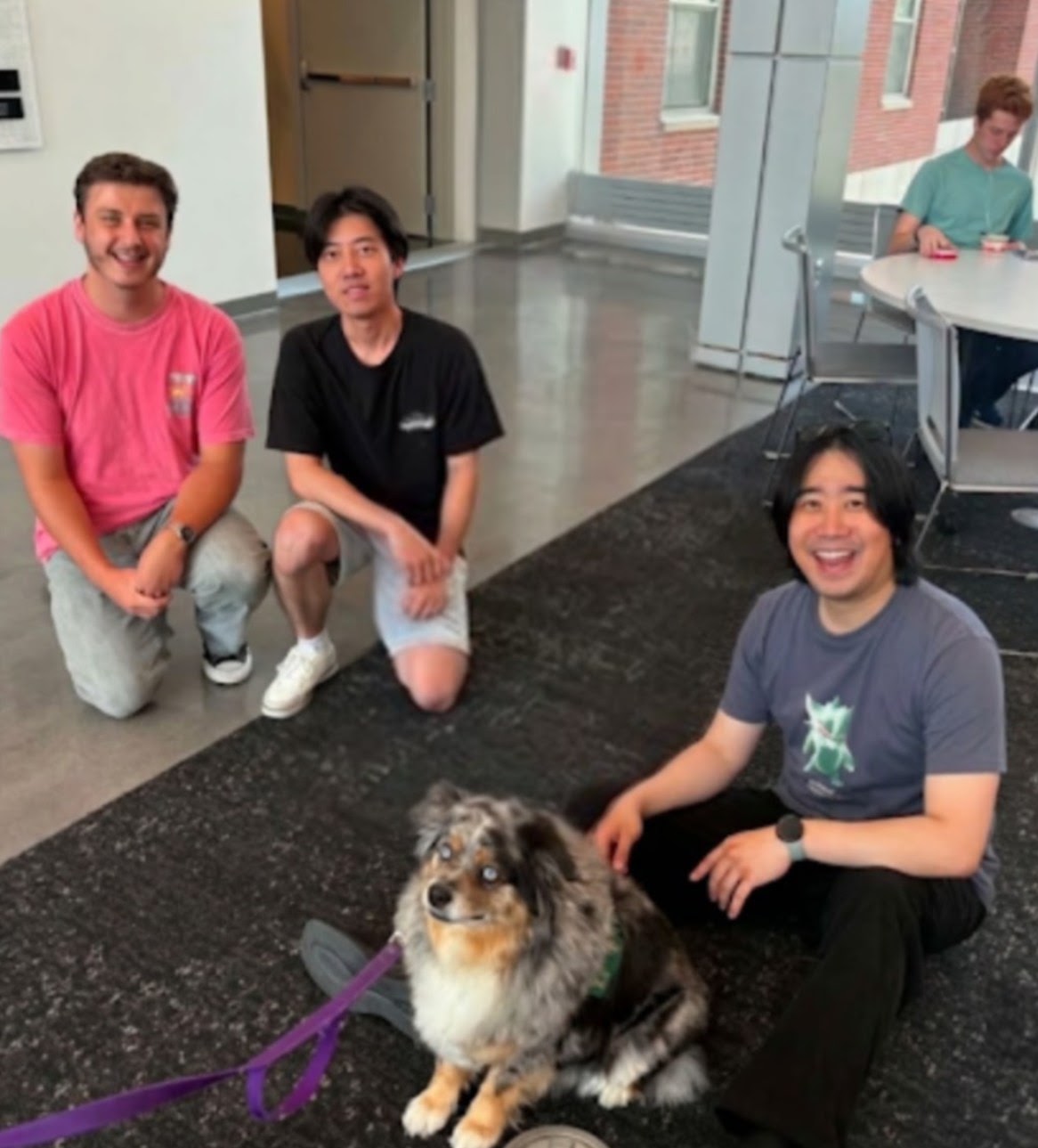 Lab members with a dog in the lab